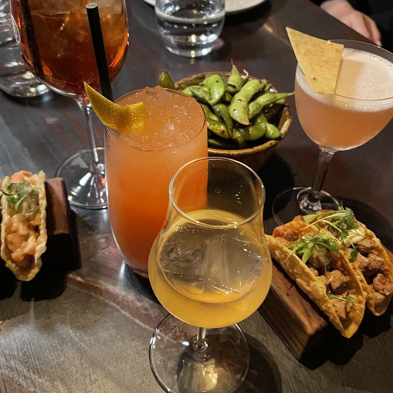 Drinks, edamame, and tacos on the table at Kazan Japanese Dining